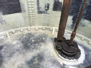 Layers of woven and chopped strand fibreglass were applied to the blast cleaned and keyed internal surfaces, encapsulating all the riveted joints and completely restructuring the tanks.